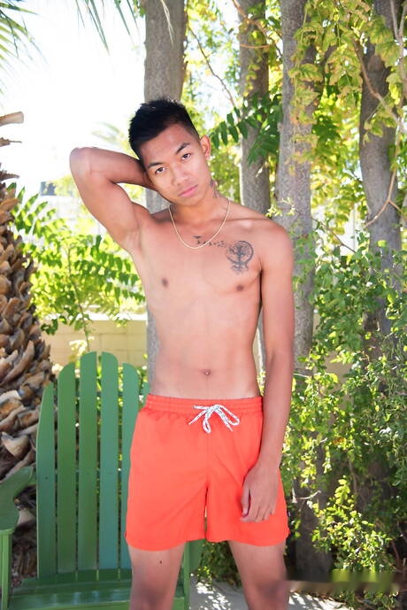 Oriental twink Alec Cruz posing nude and showing tight butt outdoor
