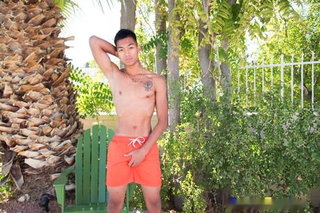 Oriental twink Alec Cruz posing nude and showing tight butt outdoor