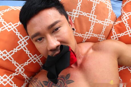 Asian bull Travis Yukarin posing nude outside