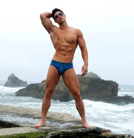 Oriental strong bull Peter Le shows a muscle body after beach walking