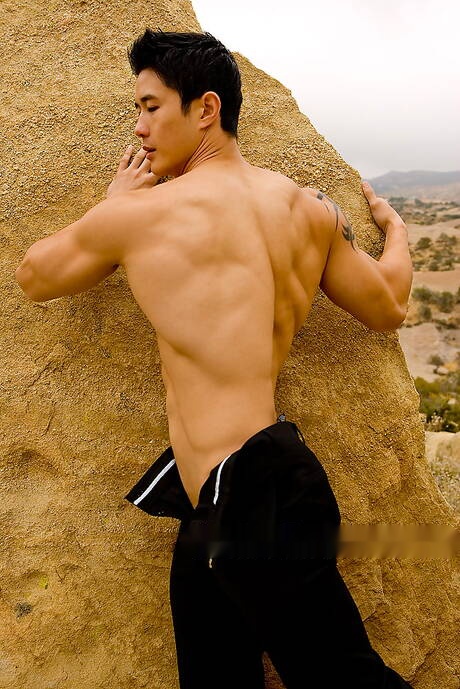 Oriental strong bull Peter Le shows a husky body outdoor