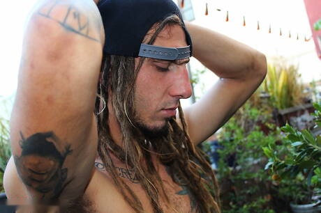 Strongman The Stereotyped 1 spielt draußen mit dem Schwanz