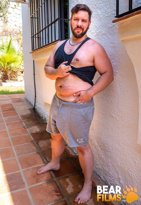 Swiss gay bear Adam Jones posing nude and showing tight ass outside