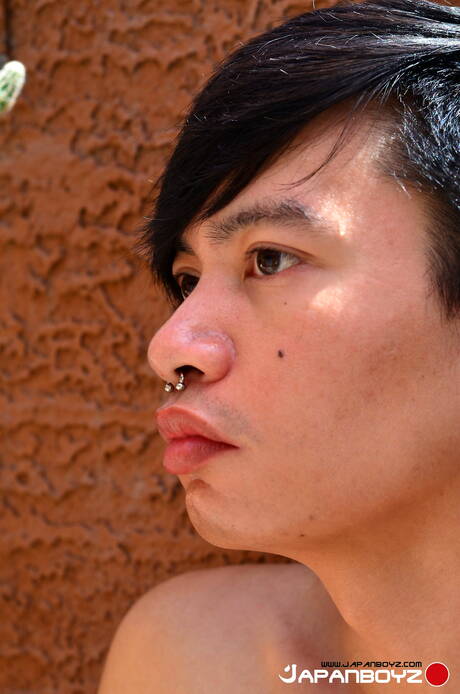 O lindo garoto oriental Chonna posando nu ao ar livre