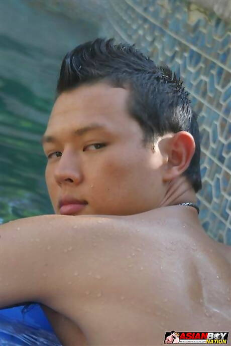 Hermoso chico oriental Westin Thalia jugando con una polla en la piscina