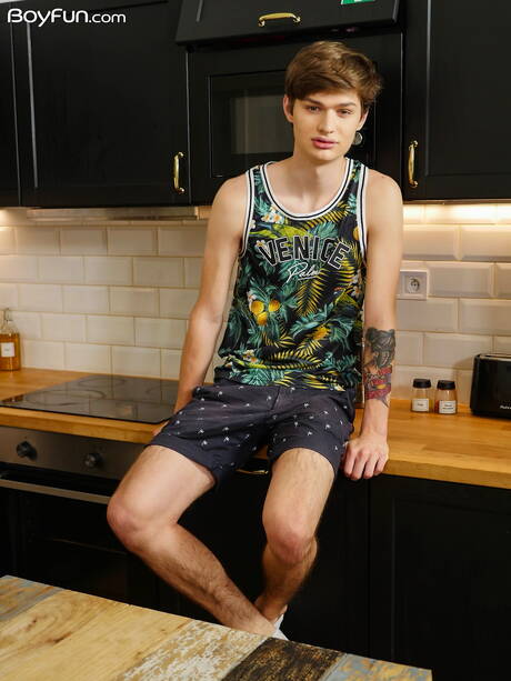 Young boy Curtis Cameron posing naked in the kitchen