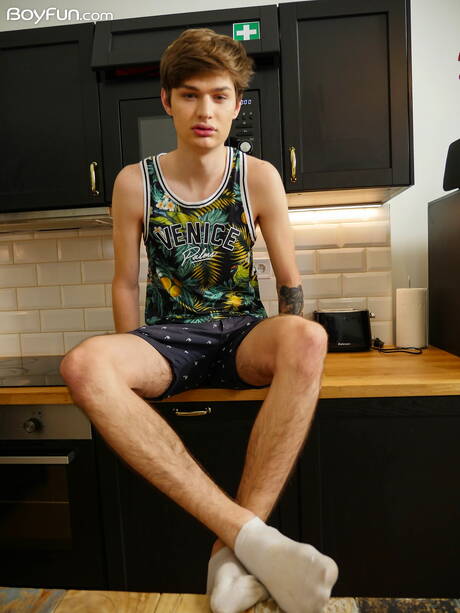 Young boy Curtis Cameron posing naked in the kitchen