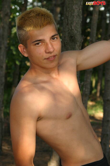 Young dude Milos posing nude and showing tight butt outside