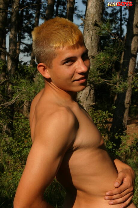 Young dude Milos posing nude and showing tight butt outside