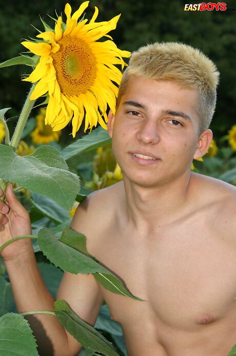 Young dude Milos posing nude and showing tight butt outside